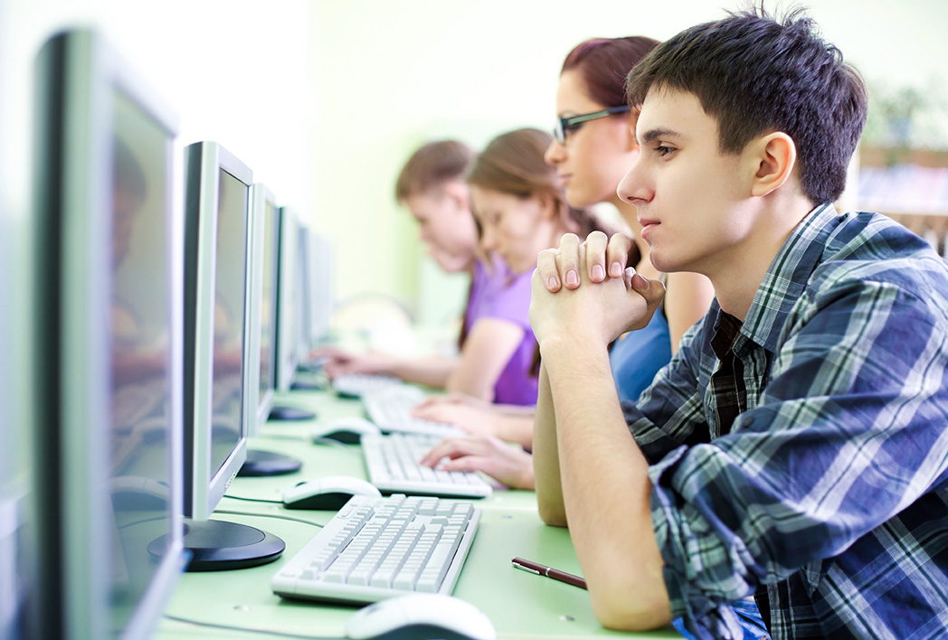 A group of students looking at computer screens.