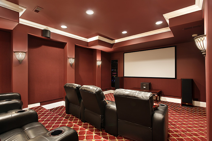 Room with a movie screen and recliners for seats.